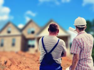 builders standing in front of a house discussing