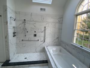 Modern open shower and tub in bright inviting space